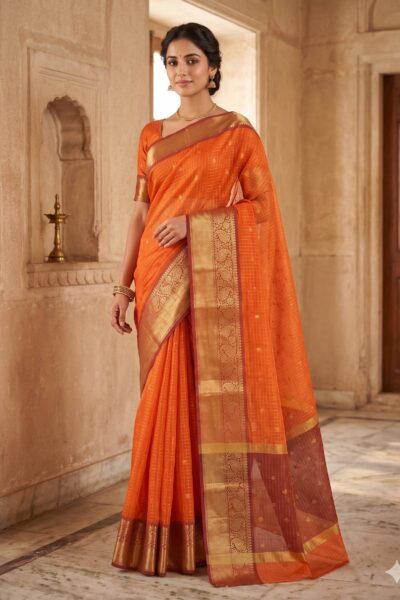 Bright orange Banaras soft silk saree draped on a mannequin, showcasing gold zari borders and subtle woven checks.