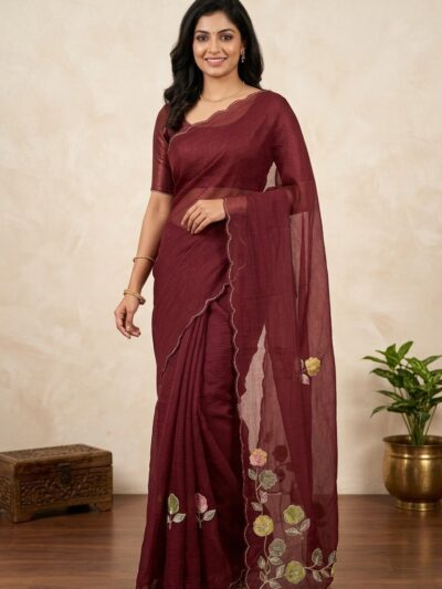 Deep maroon crush chiffon party wear saree draped on a mannequin, highlighting scalloped borders and floral embroidery motifs.