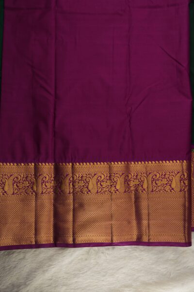 Plain magenta unstitched blouse piece featuring the intricate gold zari Kanchi border, perfectly matching the bottle green semi pattu saree.