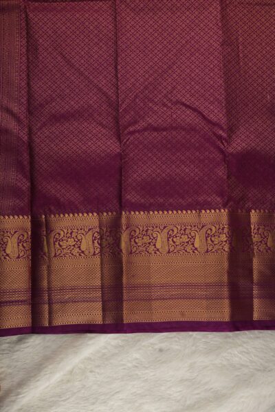 A detailed full view of the rich, dense gold zari geometric diamond brocade pallu woven on the vibrant magenta base of the premium semi Kanjeevaram silk saree.
