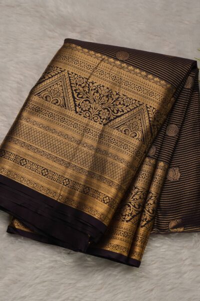 Elegantly folded outlook of the dark chocolate semi pattu art silk saree, displaying the stunning contrast between the zari striped body and the rich magenta border.