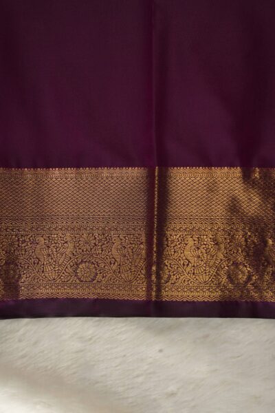 Plain dark wine unstitched blouse piece featuring the intricate gold zari Kanchi border, perfectly complementing the checked semi pattu saree.