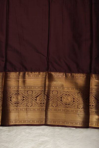 Plain coffee brown unstitched blouse piece featuring the intricate gold zari Kanchi border, perfectly matching the green semi pattu saree.