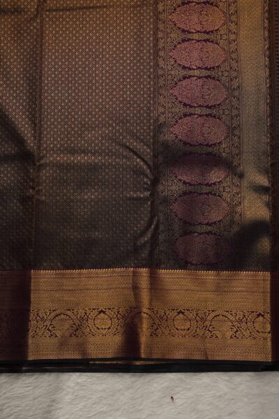 A detailed full view of the rich, dense gold zari geometric diamond brocade pallu woven on the vibrant magenta base of the premium semi pattu silk saree.