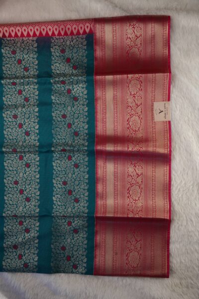 Another close-up view highlighting the beautiful contrast between the vertical zari woven green body and the rich pink gold zari traditional border.