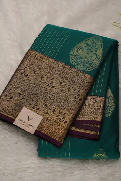 Elegantly folded outlook of the green semi pattu art silk saree, displaying the stunning contrast between the vibrant green body and the rich burgundy border.