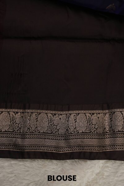 Plain coffee brown unstitched blouse piece with an elegant floral zari border matching the navy blue lightweight Kanchi Pattu saree.