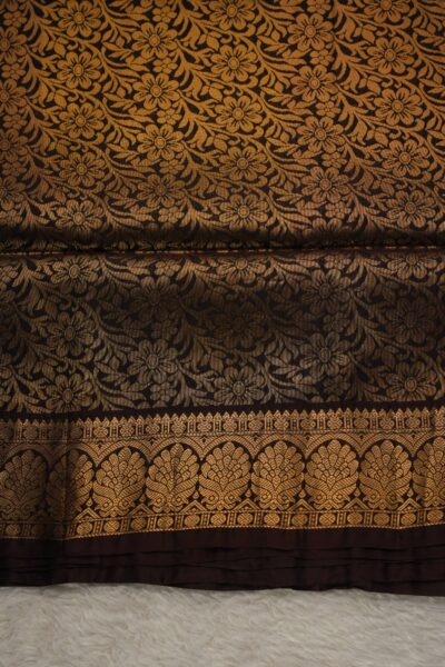 Heavy brocade snuff brown pallu of a lightweight Kanchi Pattu saree, featuring a dense all-over gold zari floral and vine pattern.