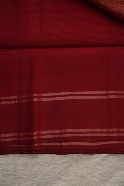 Plain deep red unstitched blouse piece with elegant metallic zari stripes matching the peach checked Pattu saree.