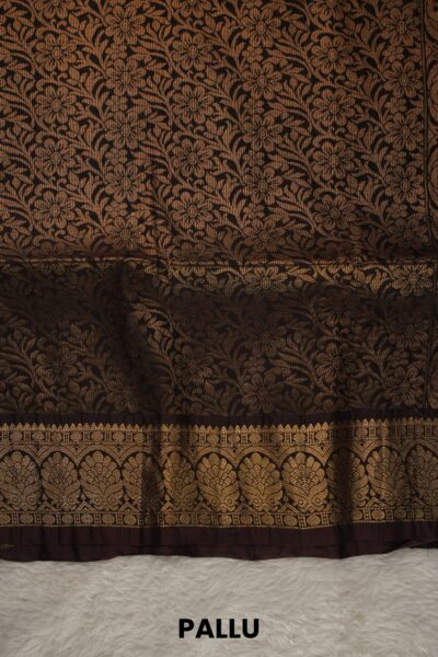 Heavy brocade coffee brown pallu of a lightweight Pattu saree, featuring a dense all-over gold zari floral and vine pattern.