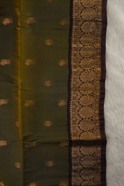 Close-up texture of an olive green lightweight Pattu saree with alternating floral and paisley metallic buttis, alongside a beautifully detailed coffee brown gold zari border.