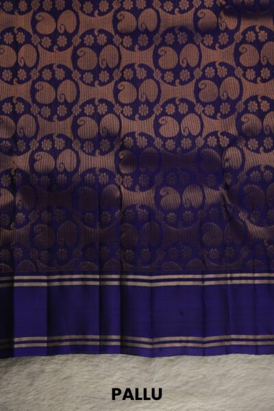 Heavy brocade navy blue pallu of a lightweight Pattu saree, featuring a dense all-over gold zari circular floral pattern.