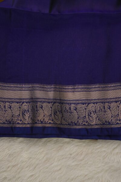 Plain deep blue unstitched blouse piece with an intricate gold zari peacock and paisley border matching the earthy mustard lightweight Pattu saree.