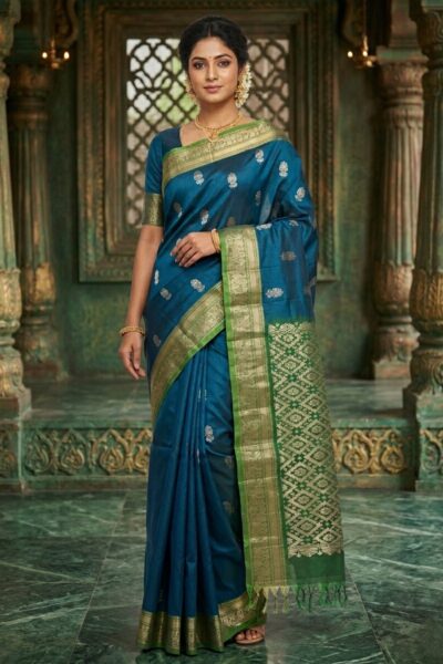 Elegant deep blue lightweight Pattu saree with floral zari buttis and a contrast green geometric zari pallu with tassels.