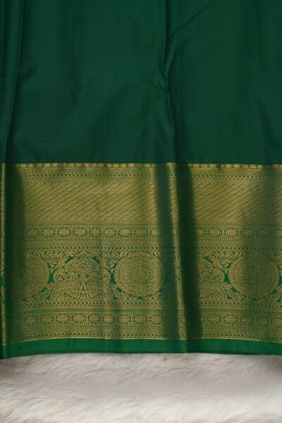Plain green unstitched blouse piece featuring the intricate gold zari Kanchi border, perfectly matching the magenta semi pattu saree.