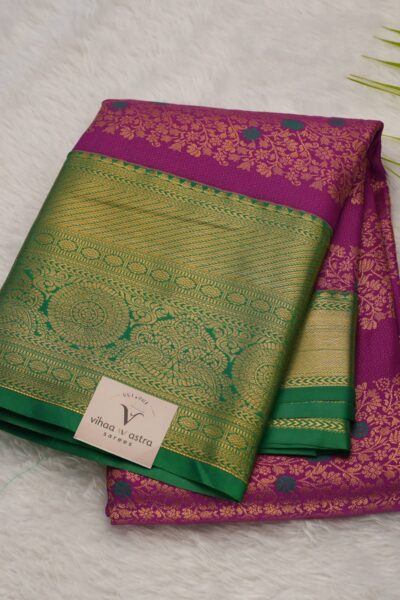 Elegantly folded outlook of the magenta semi pattu art silk saree, displaying the stunning contrast between the vibrant magenta body and the rich green border.