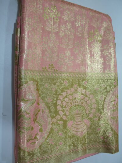 Folded Pink Semi Kanchi Pattu saree showing an all-over gold zari botanical brocade and a heavy metallic olive-gold border with a large peacock paisley and floral vase motif accented with pink Meenakari weaving.