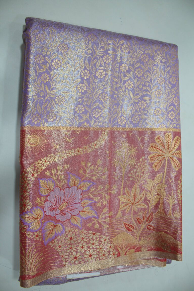 Folded lavender Semi Kanchi Pattu saree showing an all-over gold zari botanical brocade and a heavy contrasting rose-red border featuring a woven landscape with palm trees, a sun, and a large floral motif accented with purple Meenakari weaving.