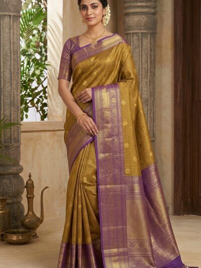 Beautiful woman wearing a golden yellow premium semi Kanchi Pattu saree featuring gold zari checks and a contrasting purple heavy zari pallu with tassels.