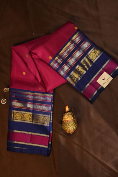 Beautifully draped outlook of the pure handloom Kanjeevaram pattu saree, displaying the stunning contrast between the pink silk and the vintage blue gap border.
