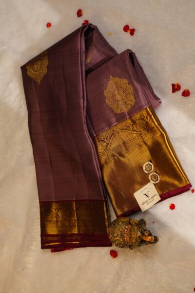 Elegantly draped outlook of the pure handloom Kanjeevaram pattu saree, displaying the stunning contrast between the rose pink silk and the deep maroon border.