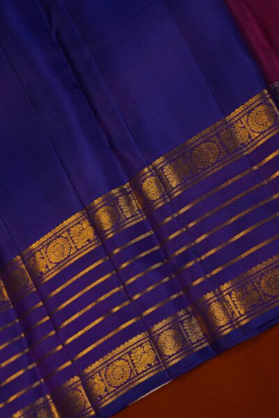 The matching contrast blue unstitched blouse piece featuring the distinct horizontal gold lines of the vintage gap border for the pink Kanjeevaram saree.