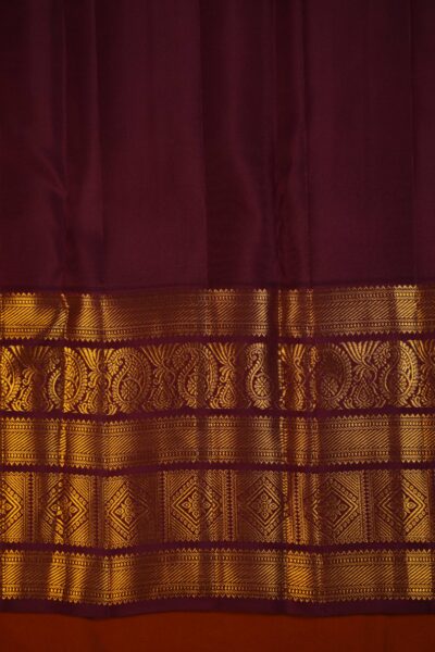 Plain maroon unstitched blouse piece featuring the intricate gold zari Kanchi border, perfectly matching the tea green checked handloom saree.