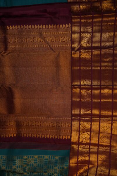 A detailed full view of the rich, dense gold zari geometric diamond brocade pallu woven on the deep maroon base of the handloom Kanjeevaram saree.