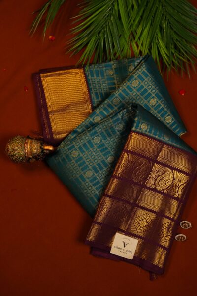 Elegantly draped outlook of the pure handloom checked Kanjeevaram pattu saree, displaying the stunning contrast between the tea green checks and the deep maroon border.
