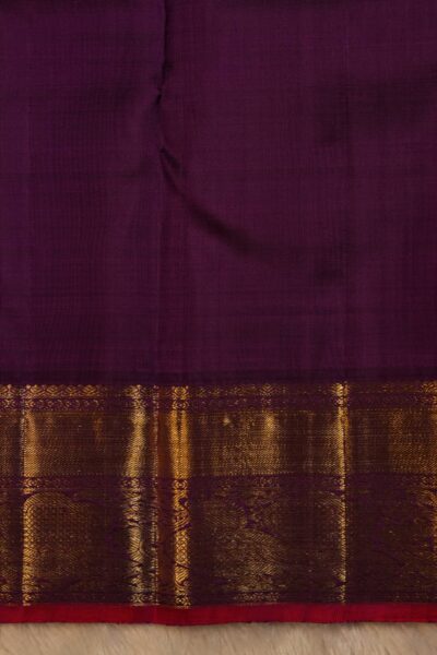 Plain magenta unstitched blouse piece featuring the distinct horizontal gold zari lines of the gap border, perfectly matching the peach Kanjeevaram saree.