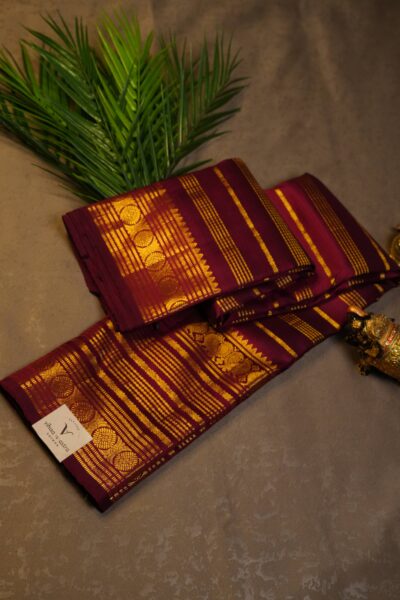 Elegantly draped full view of the pure handloom maroon Kanjeevaram pattu saree, displaying the stunning overall texture of the vintage zari stripes.