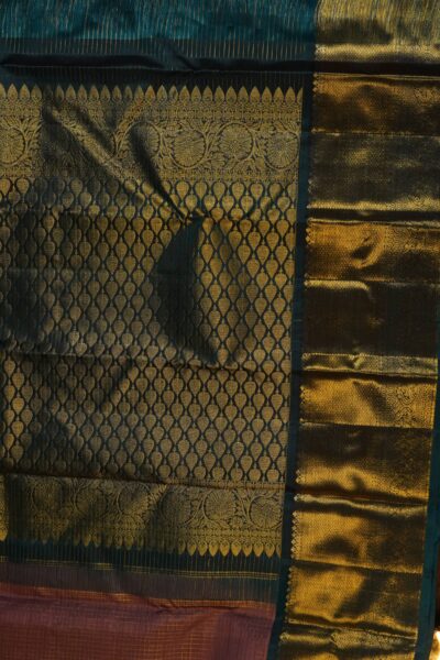 A detailed full view of the rich, dense gold zari geometric diamond brocade pallu woven on the deep navy blue base of the handloom Kanjeevaram saree.