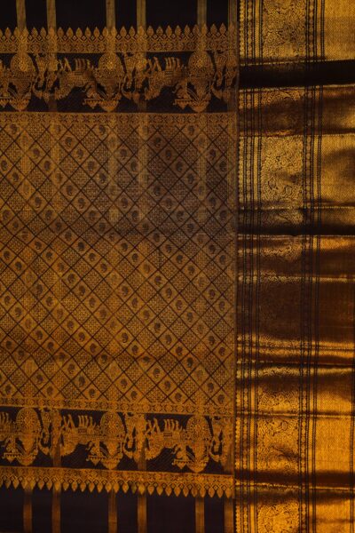 A detailed full view of the rich, dense gold zari geometric diamond brocade pallu woven on the deep brown base of the handloom Kanjeevaram saree.