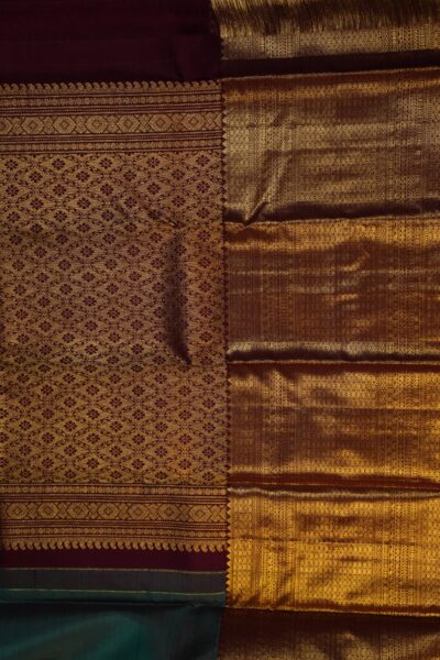 A detailed full view of the rich, dense gold zari geometric diamond brocade pallu woven on the deep maroon base of the handloom Kanjeevaram saree.