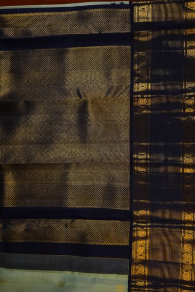 A detailed full view of the rich, dense gold zari geometric diamond brocade pallu woven on the deep navy blue base of the handloom Kanjeevaram saree.