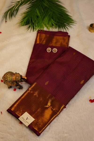 Elegantly draped full view of the pure handloom maroon Kanjeevaram pattu saree, displaying the stunning overall texture of the vintage zari checks.