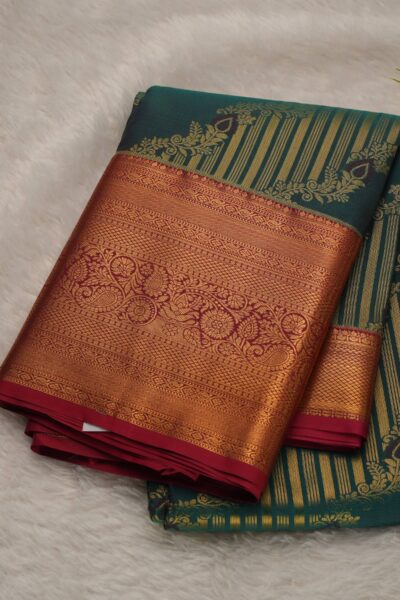 A wide-angle draped outlook of the sea green semi Kanjeevaram pattu saree, highlighting the striking pink contrast border and beautiful drape.
