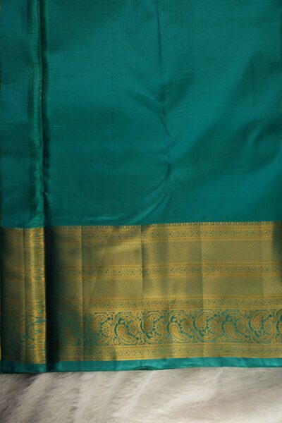 Plain sea green unstitched blouse piece featuring the intricate gold zari Kanchi border, perfectly matching the mustard yellow checked semi pattu saree.