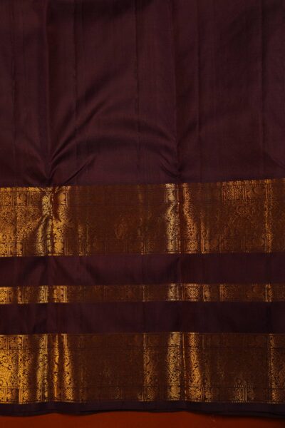Matching unstitched dark maroon blouse piece featuring the intricate gold zari Kanchi gap border to complement the light burgundy handloom saree.