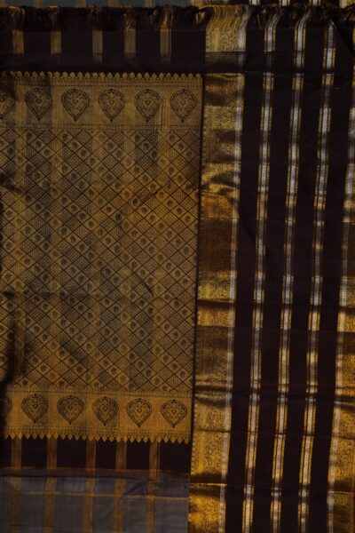A detailed full view of the rich, dense gold zari geometric diamond brocade pallu woven on the deep brown base of the handloom Kanjeevaram saree.