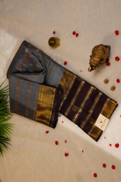 Elegantly draped outlook of the pure handloom striped Kanjeevaram pattu saree, displaying the stunning contrast between the elephant grey body and the deep brown border.