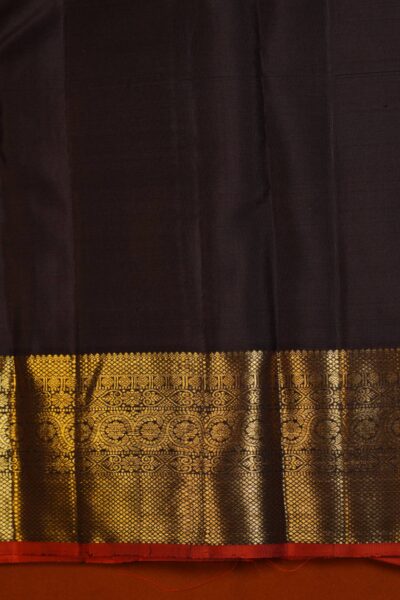 Matching unstitched plain coffee brown blouse piece featuring the heavy gold zari border and red Korvai edge for the handloom Kanjeevaram saree.